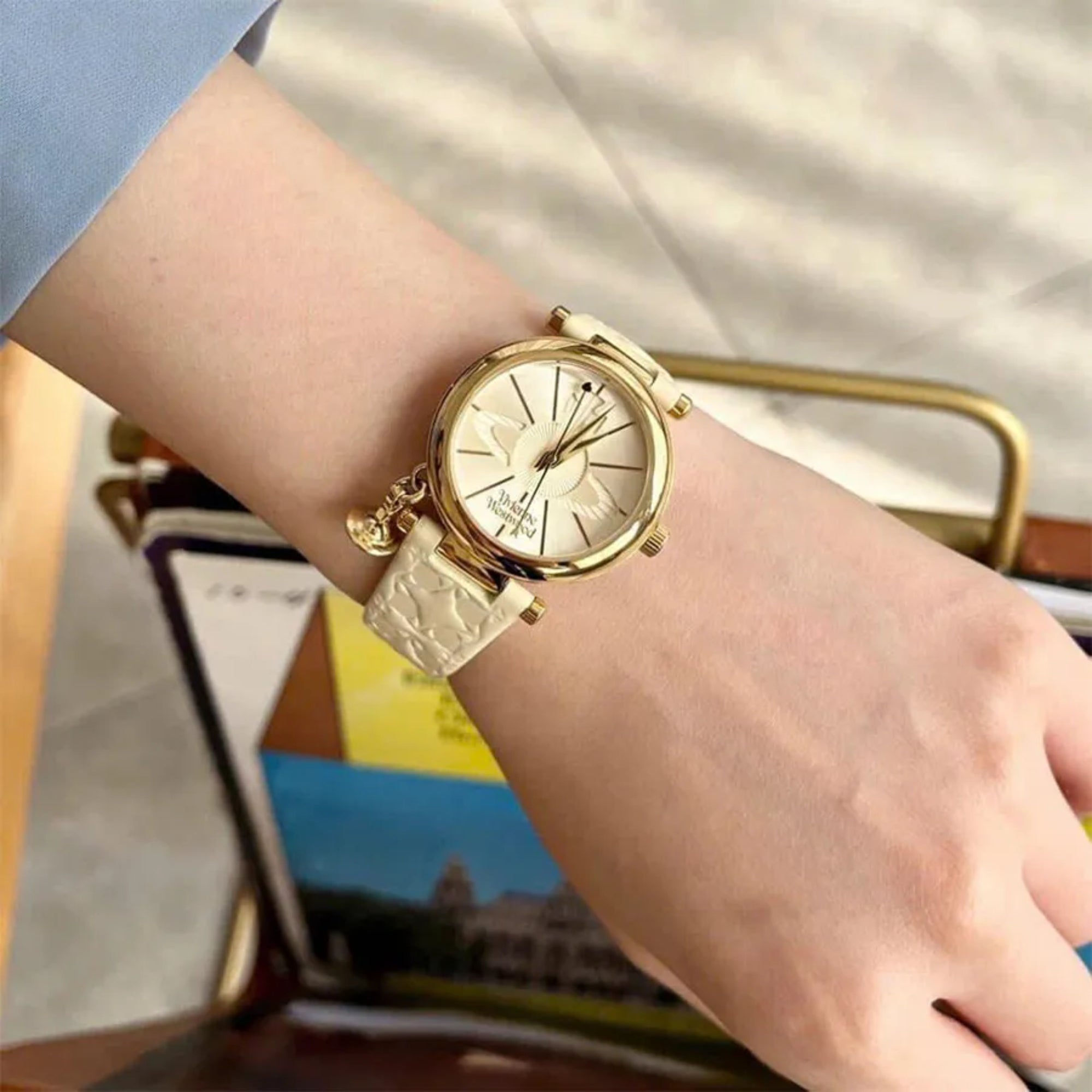 Vivienne Westwood Orb II women's watch with a cream dial and cream leather strap. Shown at an angle.