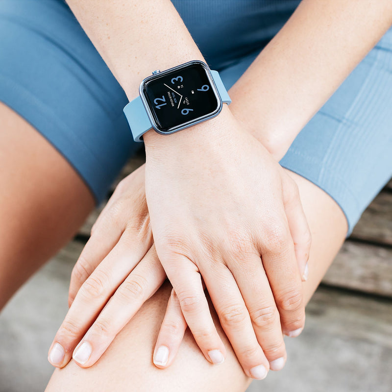 Smartwatch with a digital display showing heart icons on a person’s wrist.