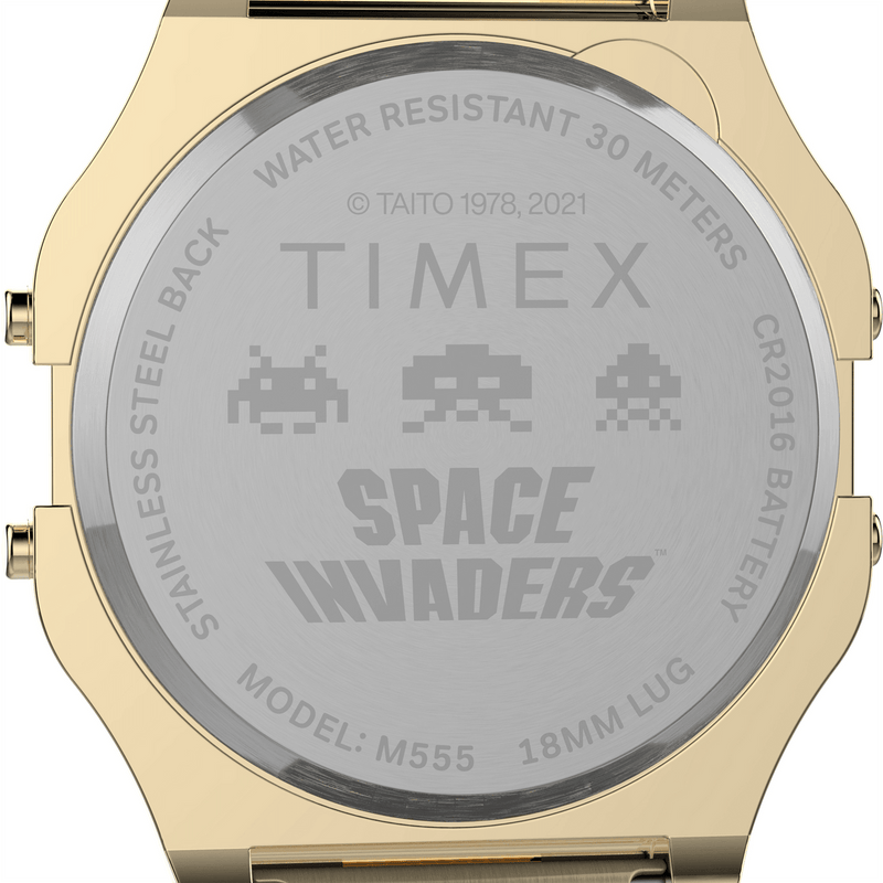 Back of a gold-toned Timex watch featuring a Space Invaders design engraving.