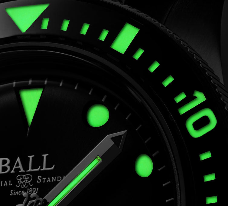 Close-up view of a watch face with glowing green markings and hands.