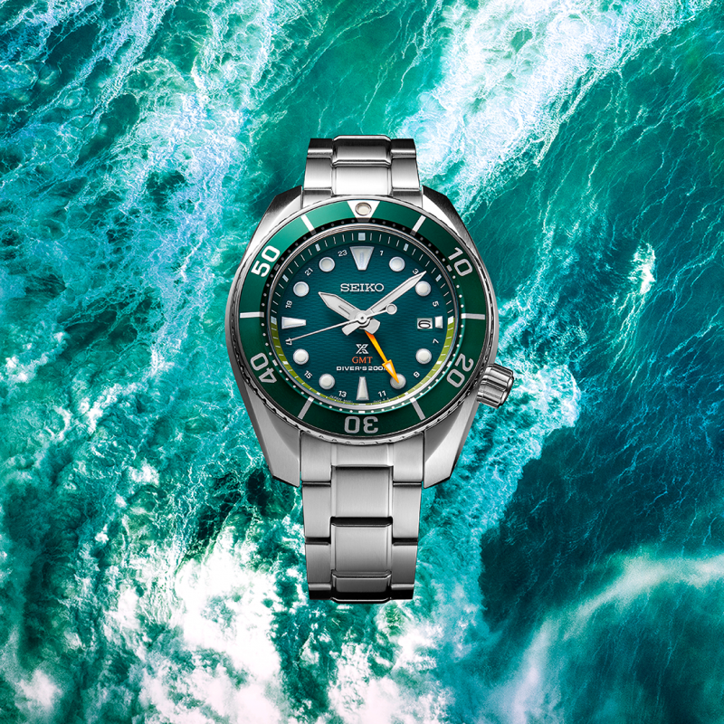 Stainless steel dive watch with a green dial and bezel.