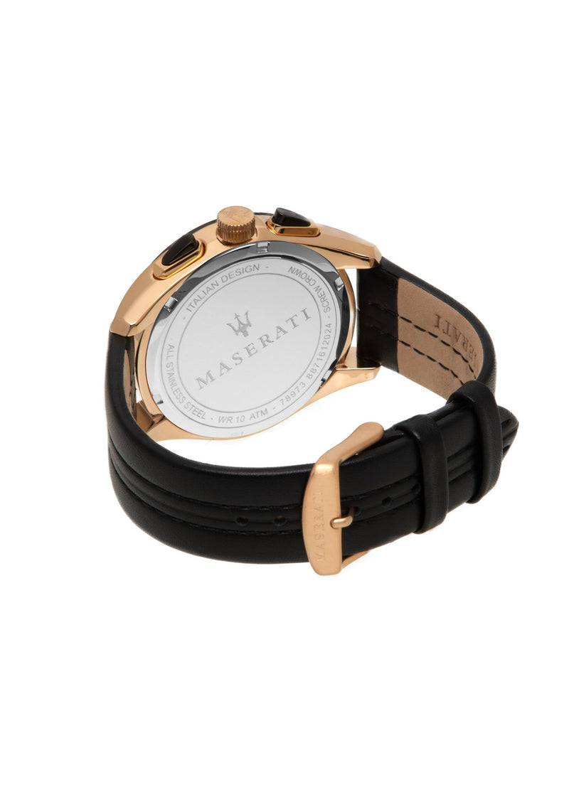 Wristwatch with a black leather strap and gold-toned case, showing its back side.