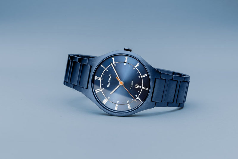 Sleek blue wristwatch with a round face and metal bracelet.