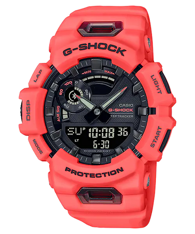 Bright coral-colored G-Shock digital watch with a complex display and rugged design.