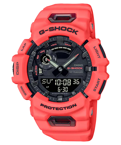 Bright coral-colored G-Shock digital watch with a complex display and rugged design.