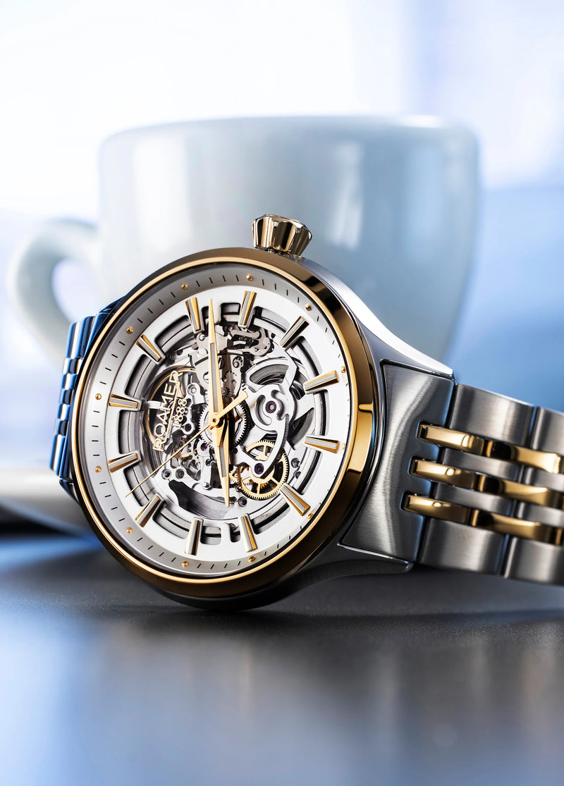 Luxury wristwatch with a visible skeleton mechanism and mixed metal construction.