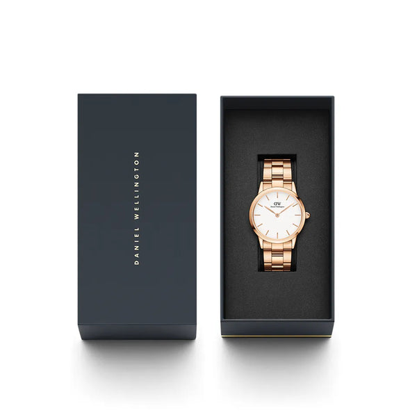 Rose gold wristwatch with a metal link bracelet displayed in a dark presentation box.