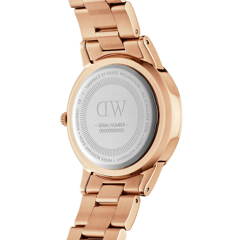 Rose gold wristwatch with a metal band and engraved caseback.