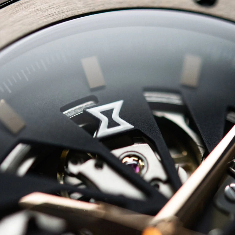 Close-up view of a luxury watch’s intricate mechanical movement, focusing on a gear marked with a stylized ’Z’ symbol.