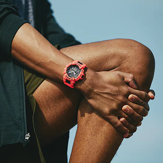 Red sports watch worn on a person’s wrist.