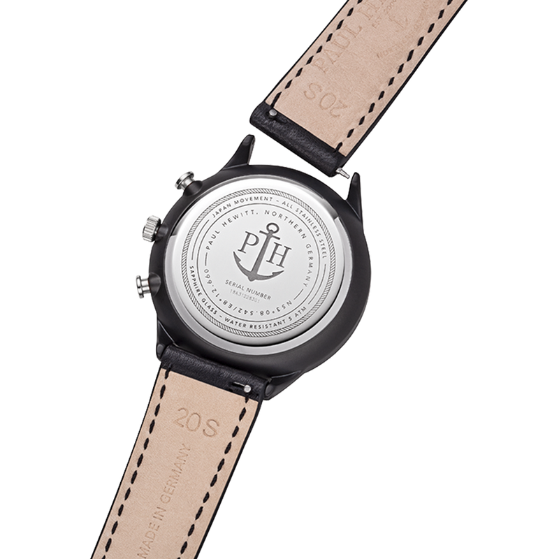 Back of a wristwatch with a leather strap and engraved metal case.