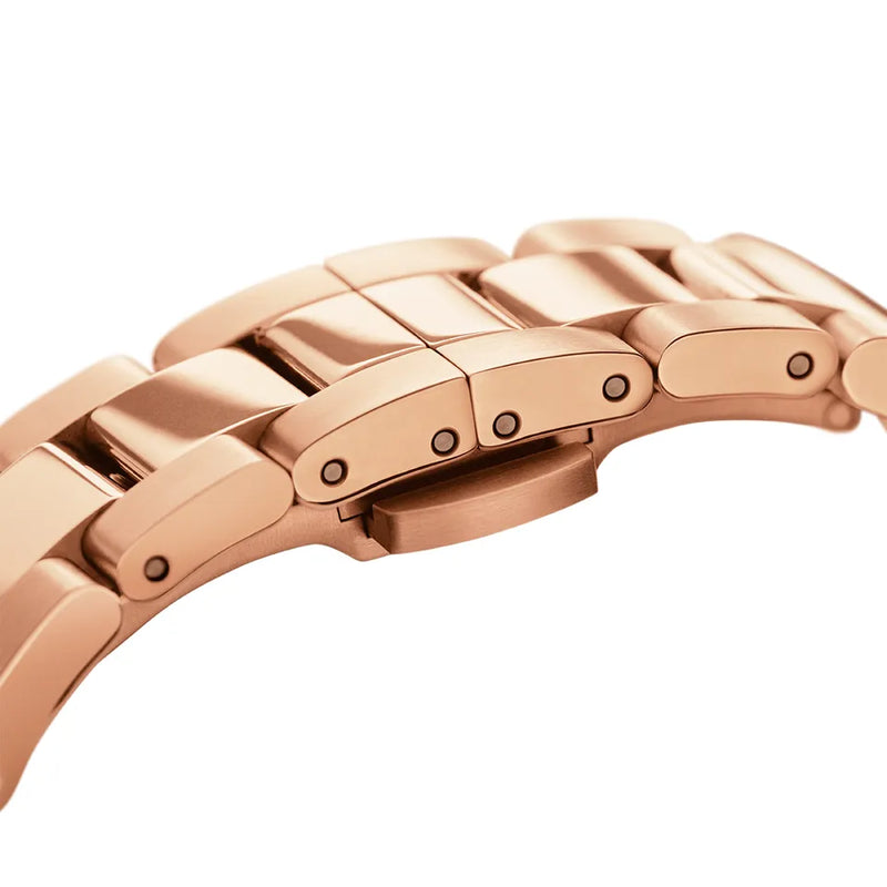 Rose gold metal watch band with linked segments and visible screws.