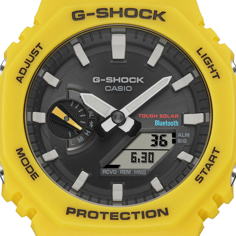 Yellow G-Shock watch face with a black dial and digital display.