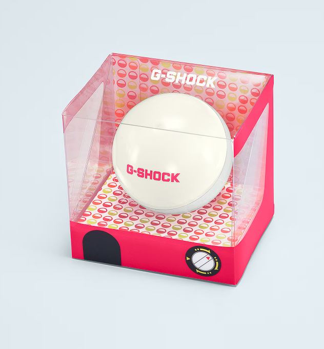 Pink and white G-Shock watch display case with a spherical compartment.