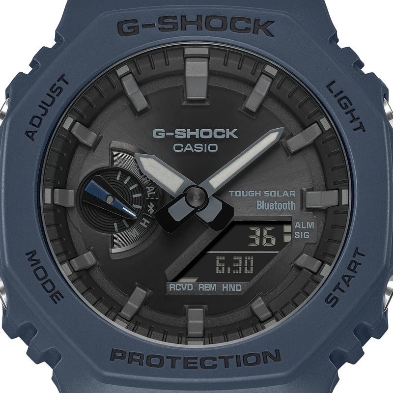 G-Shock watch with a blue casing and dark gray dial face displaying digital and analog time.