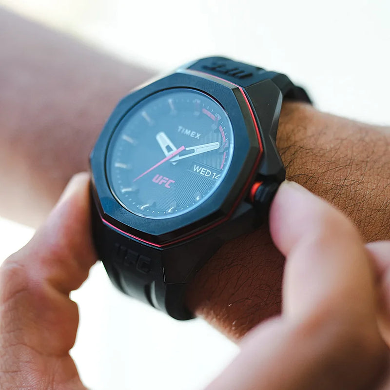 Sleek black smartwatch with a round digital display worn on a wrist.