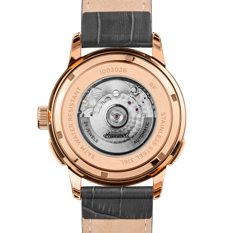 Back of a luxury wristwatch with visible mechanical movement through a transparent case back.