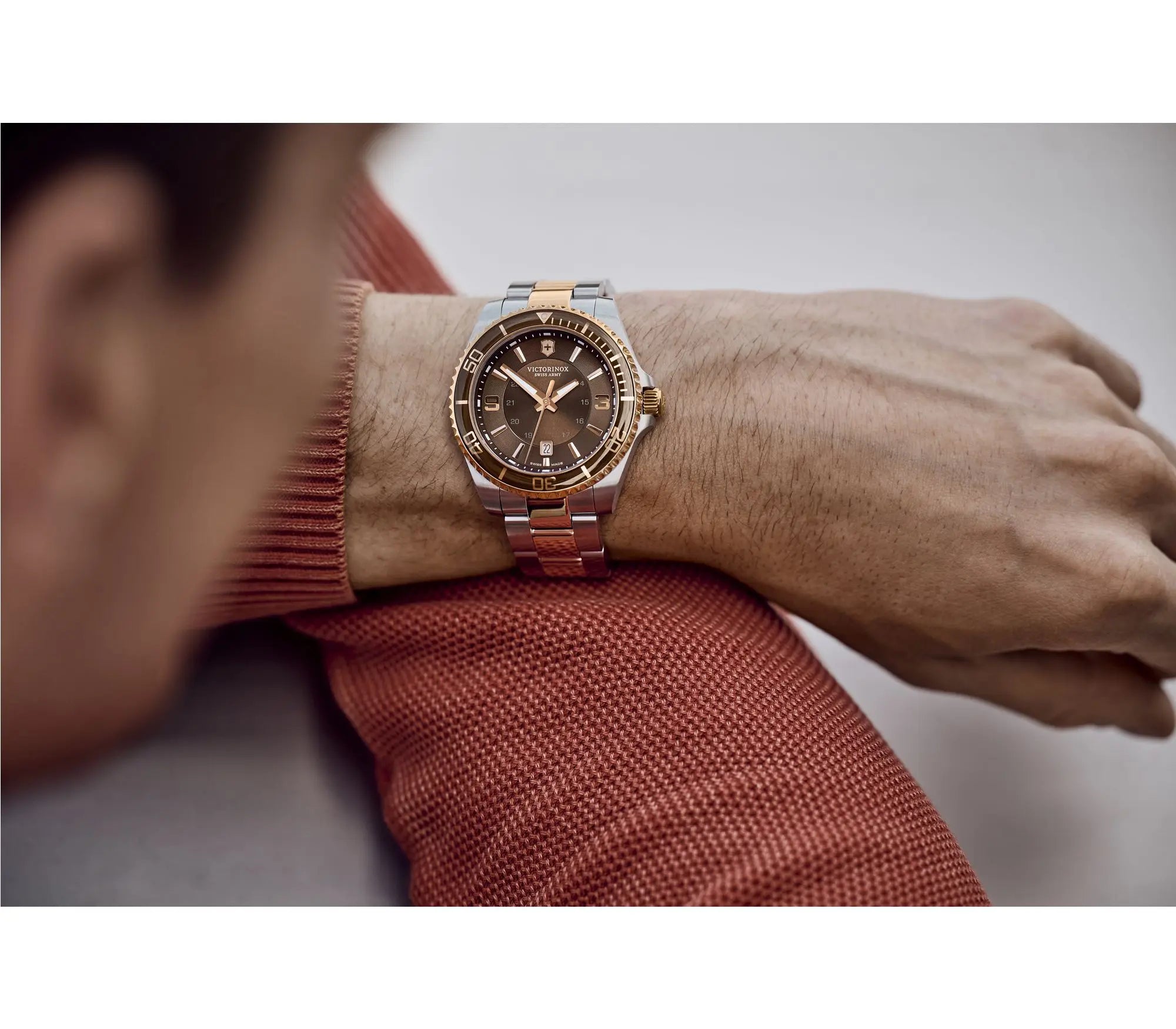 Luxury wristwatch with a brown dial and two-tone metal bracelet.