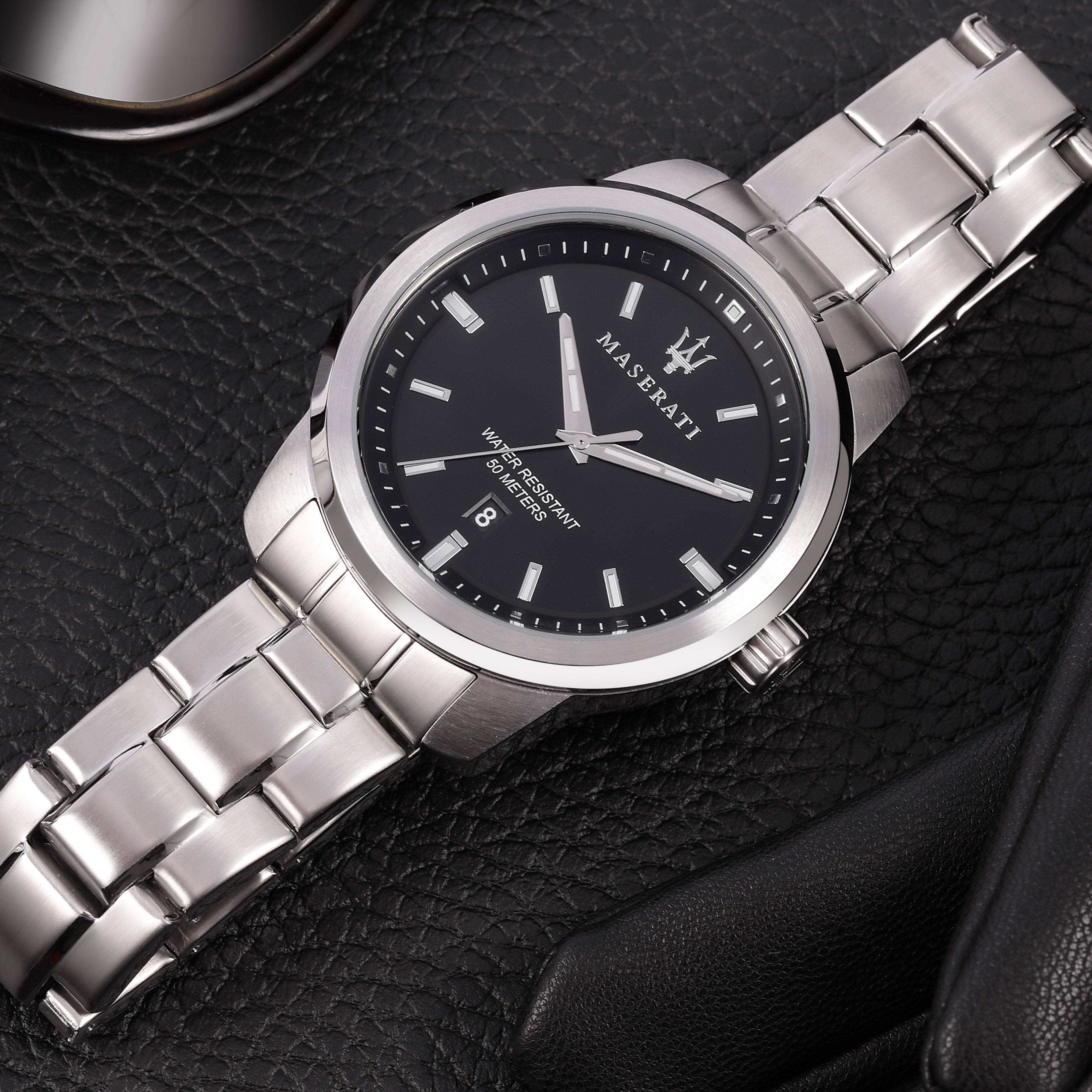Silver wristwatch with a black dial and metal bracelet.