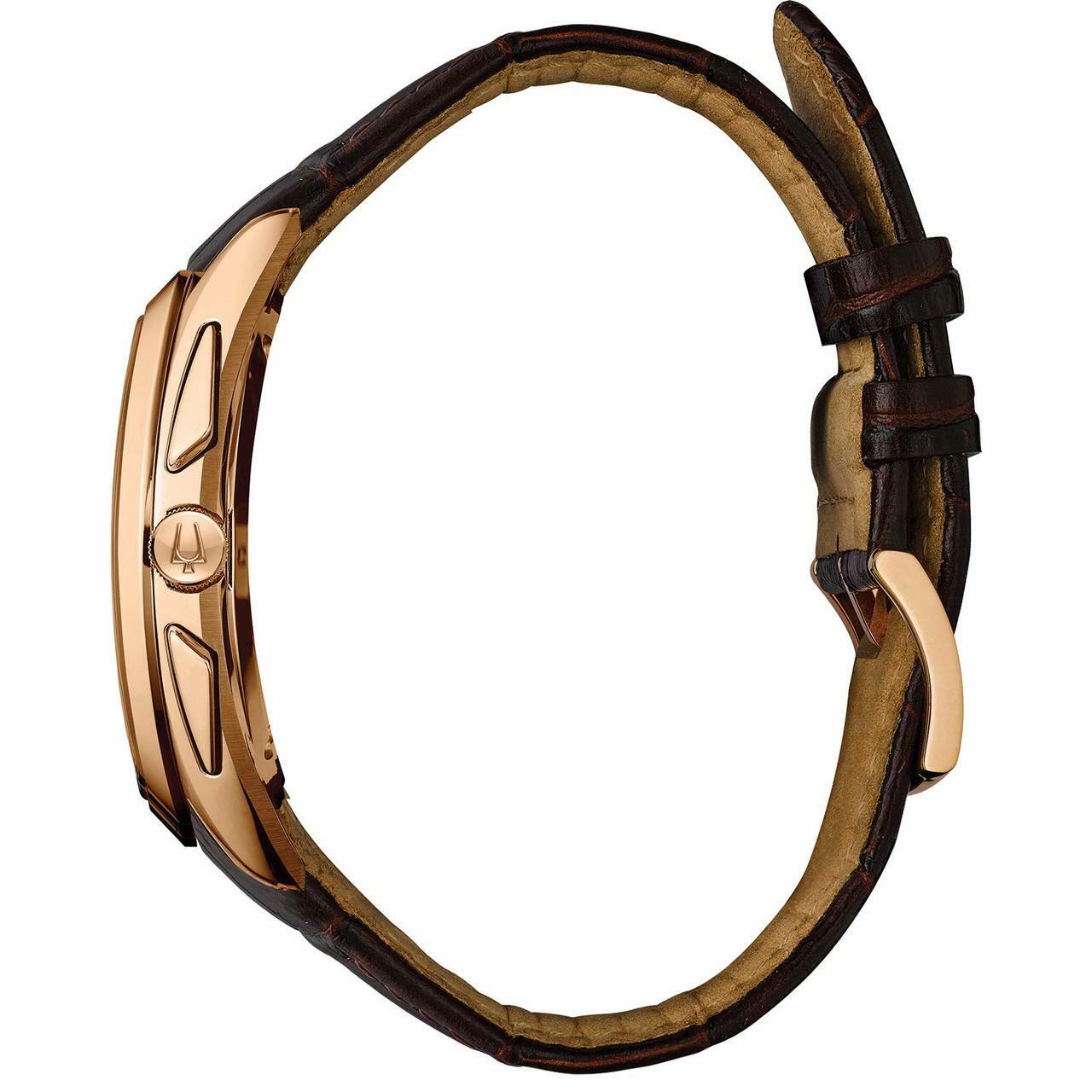 Gold-toned wristwatch with a brown leather strap.