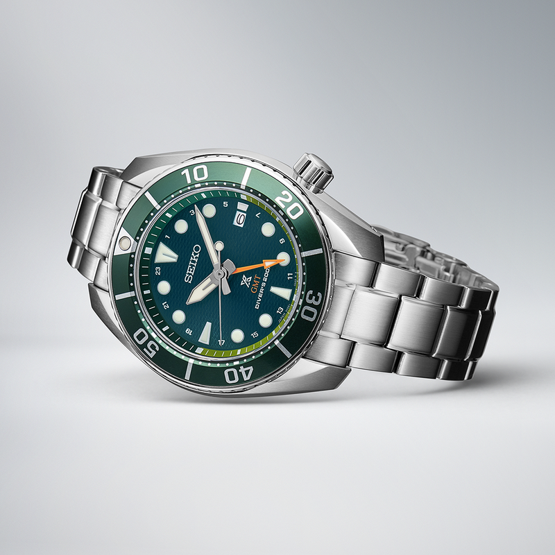 Stainless steel wristwatch with a green dial and bezel.