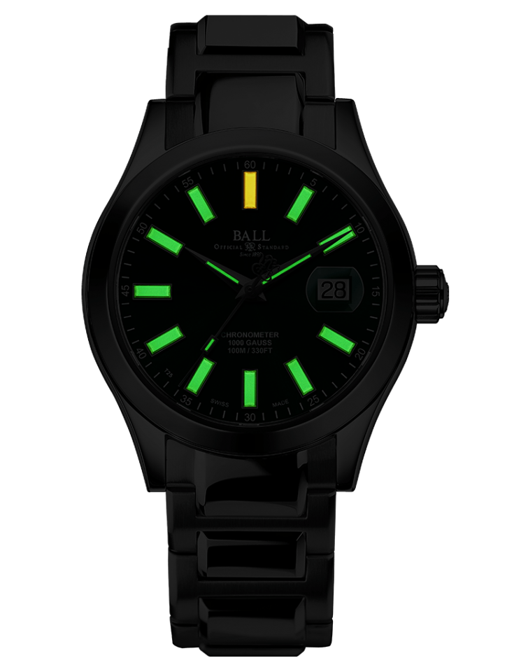 Black wristwatch with glowing green and yellow hour markers on its face.