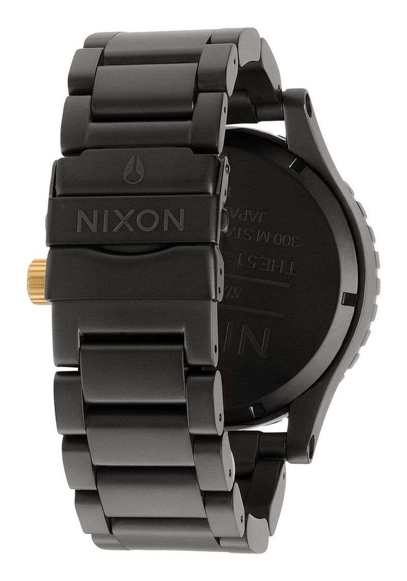Black wristwatch with a metal link band and gold accents.
