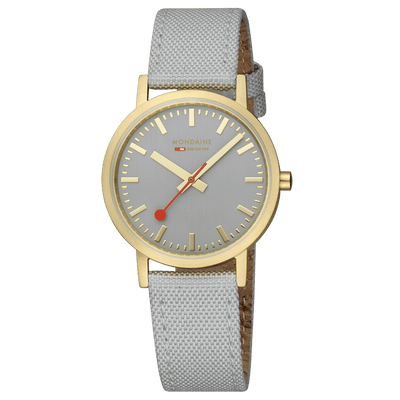 Wristwatch with a gold-tone case, gray dial, and light gray fabric strap.