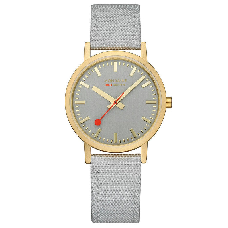 Wristwatch with a gold-tone case, gray dial, and light gray fabric strap.