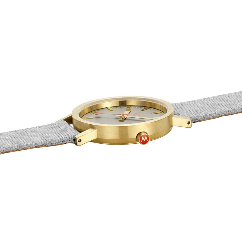 Gold-toned wristwatch with a gray leather strap.