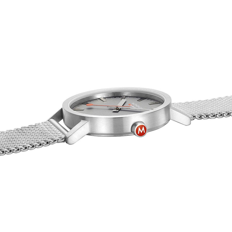 Sleek silver wristwatch with a mesh metal band and red logo on the side.