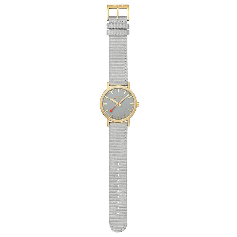 Wristwatch with a gray leather strap and gold-toned case.