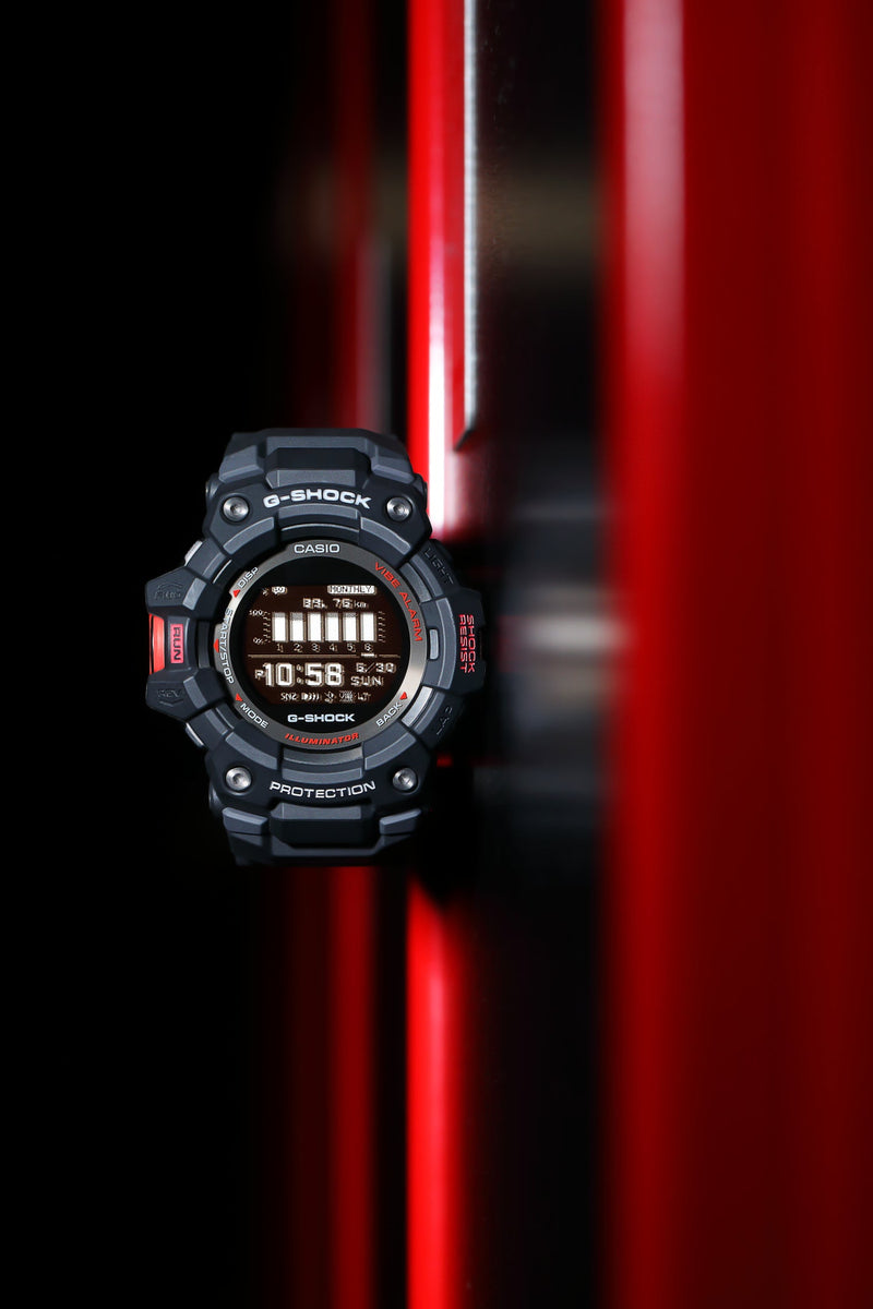Rugged digital sports watch with a circular display showing the time.