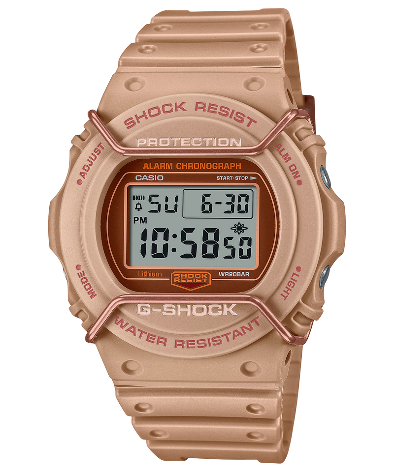 Digital wristwatch with a beige/rose gold-colored case and band featuring ’G-SHOCK’ branding.