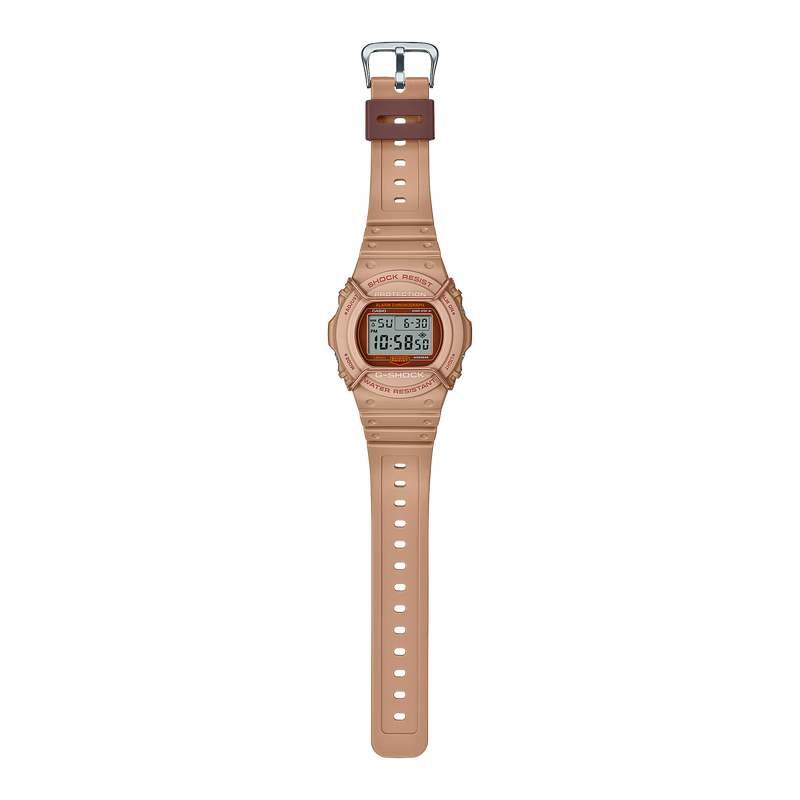 Digital wristwatch with a beige or light pink plastic band and case.