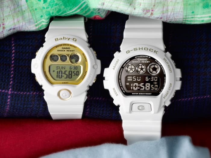 Two white digital wristwatches, one labeled Baby-G and the other G-Shock, displaying different time readouts.