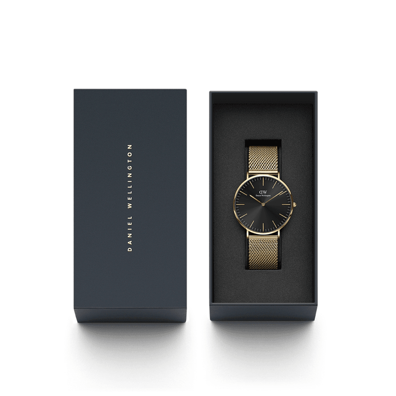 Elegant wristwatch with a black face and gold mesh band in a presentation box.