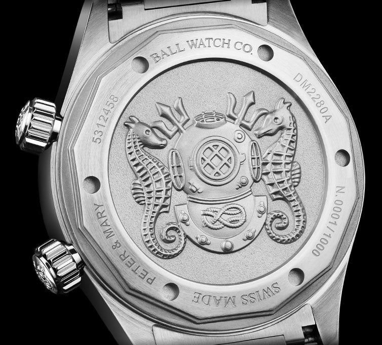 Engraved watch caseback featuring a detailed diving helmet design with seahorses.