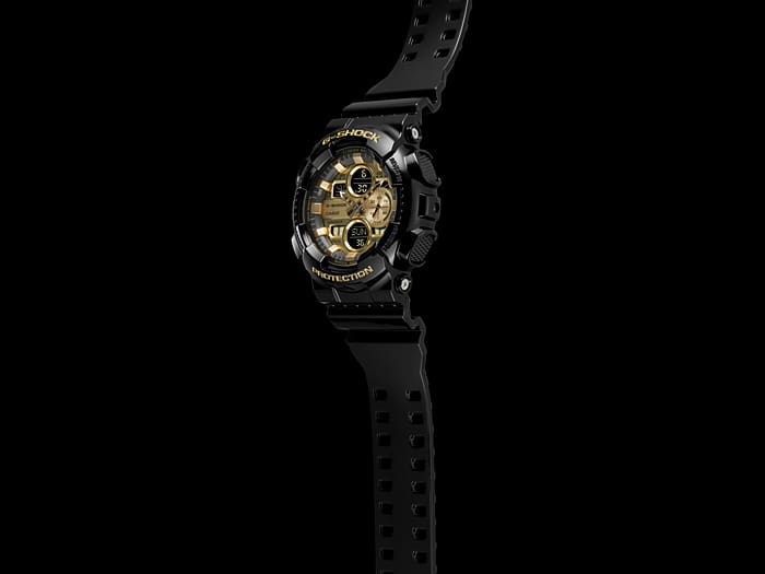 Rugged black and gold wristwatch with a digital display and multiple subdials.