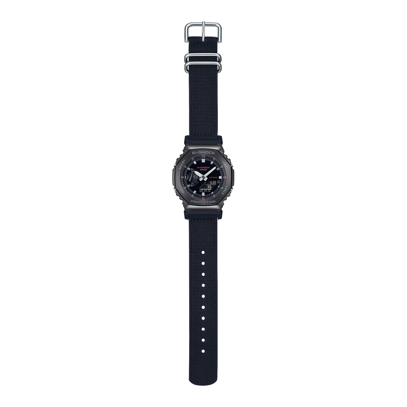 Black digital wristwatch with a round face and fabric strap.