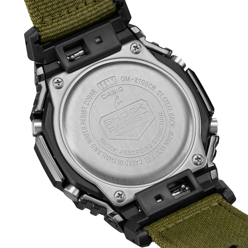 Back of a rugged digital watch with a green fabric strap.