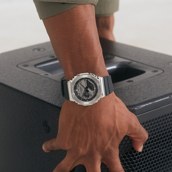 Silver and black wristwatch with a round face and metal bracelet.