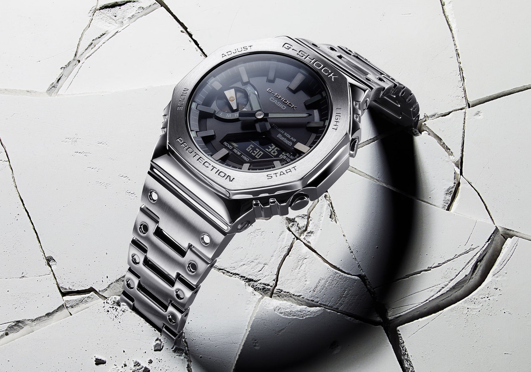 Luxury stainless steel wristwatch with a dark face and metallic bracelet.