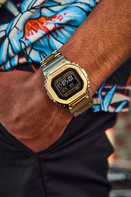 Gold-colored digital wristwatch with a square face displaying the time.