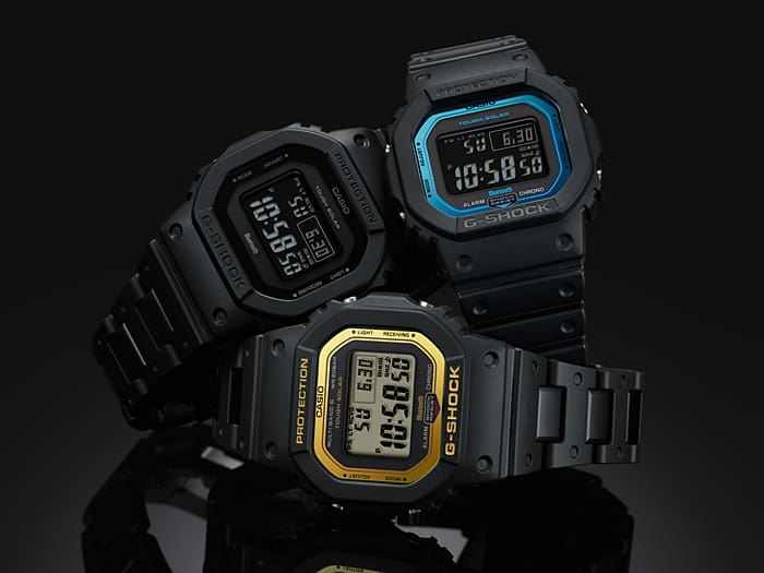 Three digital sports watches with square faces and different colored accents.