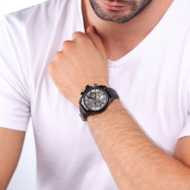 Wristwatch with a black leather strap and chronograph-style dial.