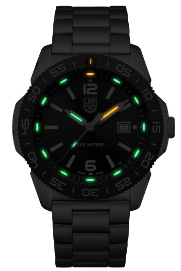 Black wristwatch with glowing green and orange markers on the dial.
