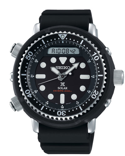 Seiko dive watch with a black dial and bezel on a rubber strap.