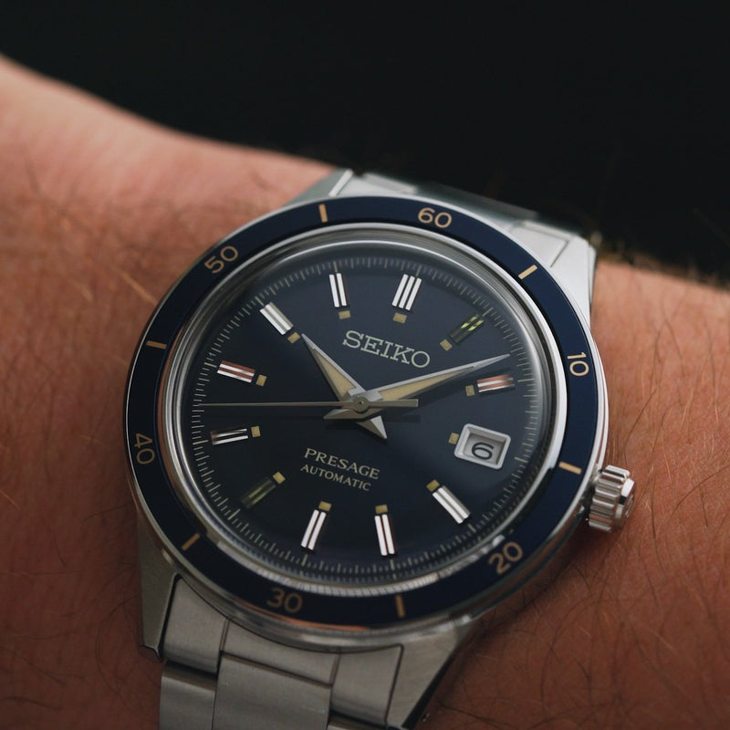 Seiko wristwatch with a dark blue dial and metal bracelet.