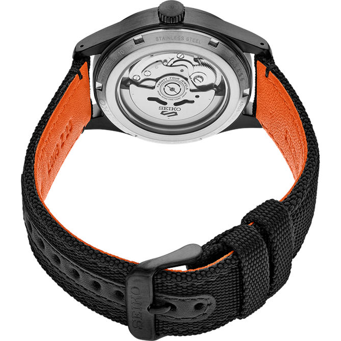 Wristwatch with a black fabric strap and visible mechanical movement through the transparent case back.